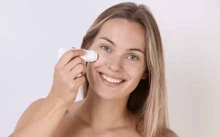 Une mannequin utilise un stick nettoyant chauffant pour le visage. Ce soin démaquillant tout-en-un élimine efficacement le maquillage et les impuretés.